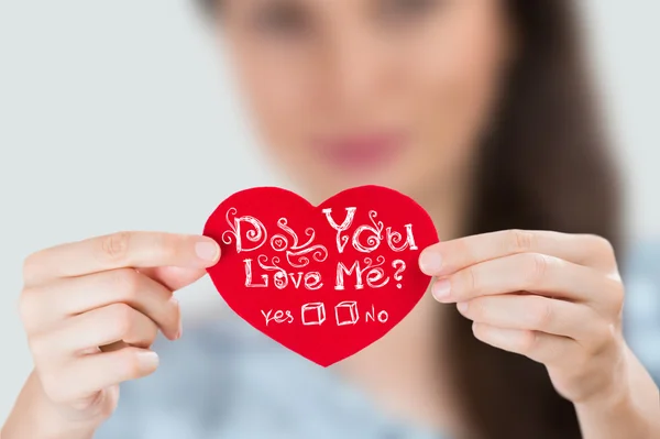 Woman holding red heart with question: Do you love Me? — Stock Photo, Image