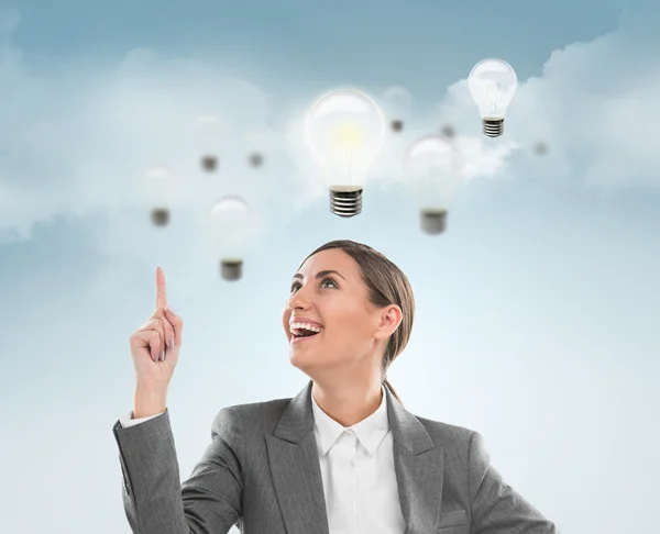 Woman with lamps overhead, idea concept — Stock Photo, Image