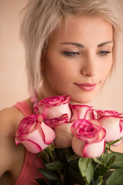 Woman with bouquet of pink roses Stock Picture