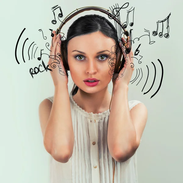 Girl with headphones on the grey background — Stock Photo, Image