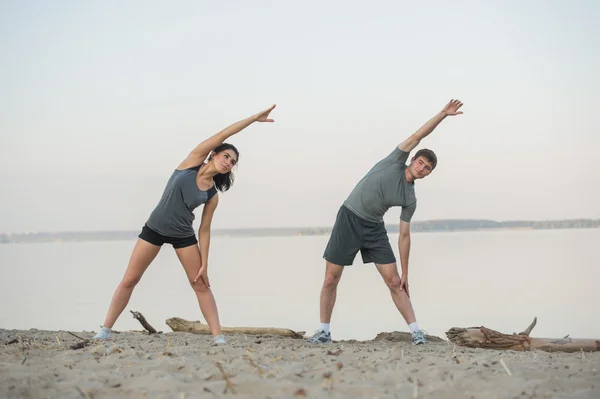 Young couple stretching — Stock Photo, Image