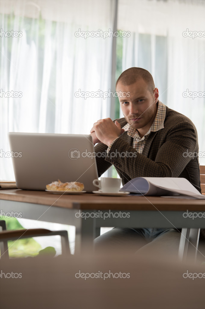 Businessman working at cafe using laptop