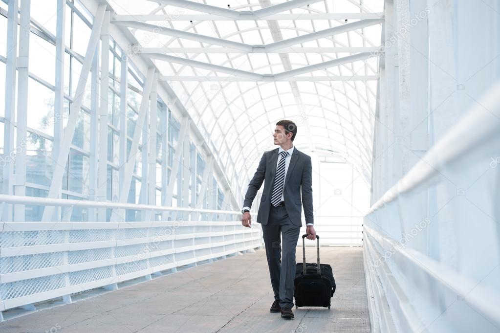Businessman at airport with suitcase
