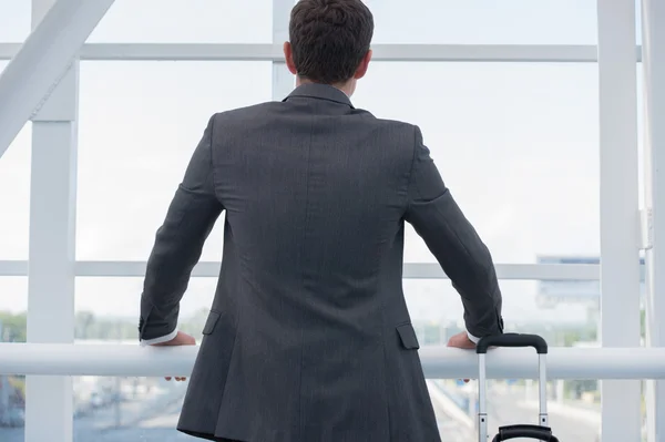 Businessman at the airport with suitcase — Stock Photo, Image