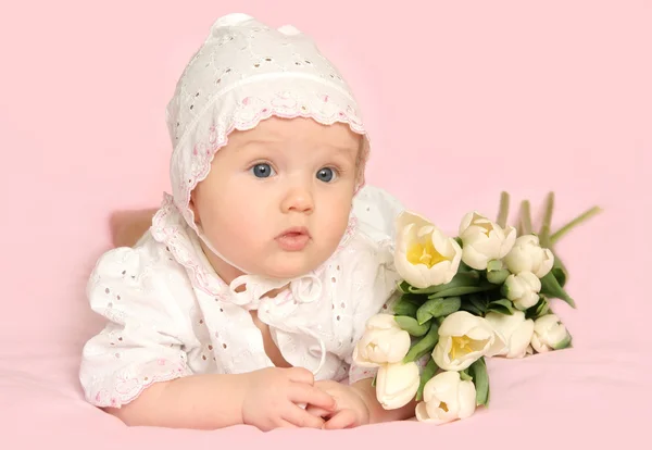 Baby girl with flowers Stock Image