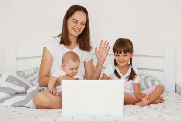 Indoor Shot Happy Positive Female Infant Preschooler Daughter Holding Laptop — Stock Photo, Image