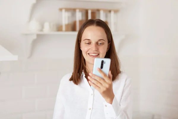 Indoor Shot Positive Smiling Female Dark Hair Looking Cell Phone — Stock Photo, Image