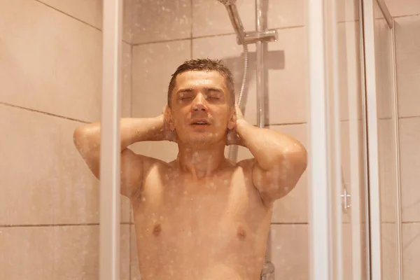 Zrelaksowany Mężczyzna Myjący Włosy Ciało Stojący Pod Wodą Kabinie Prysznicowej — Zdjęcie stockowe