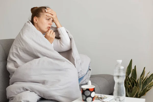 Indoor Shot Unhealthy Woman Hair Bun Sitting Sofa Wrapped Blanket — Stock Photo, Image