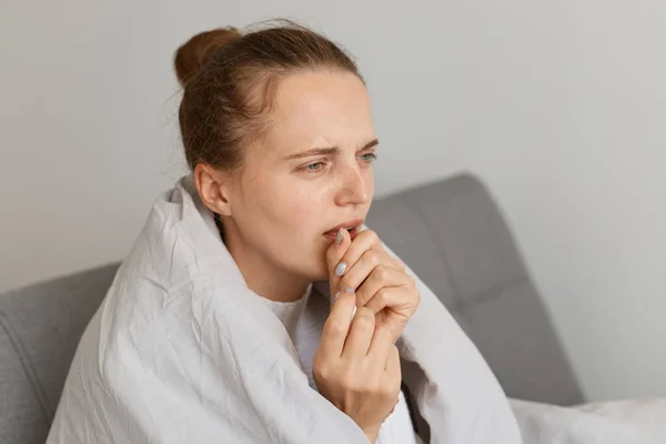 Sick Unhealthy Woman Hair Bun Sitting Sofa Wrapped Blanket Coughing — Stock Photo, Image