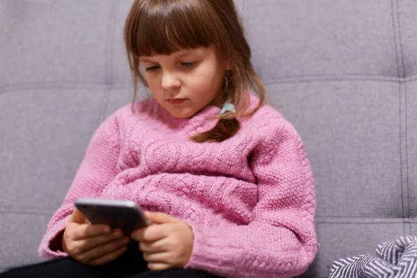 Serious Concentrated Dark Haired Female Child Wearing Warm Pink Sweater — Stock Photo, Image