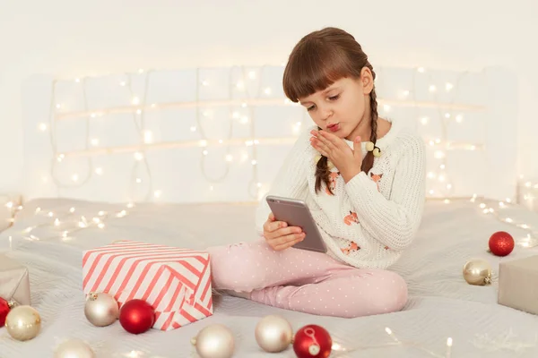 Indoor Shot Charming Adorable Little Girl Sitting Bed Baubles Taking — Stock Photo, Image