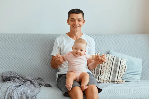 Handsome Young Brunette Man Sitting Sofa Home Holding Infant Daughter — Foto Stock