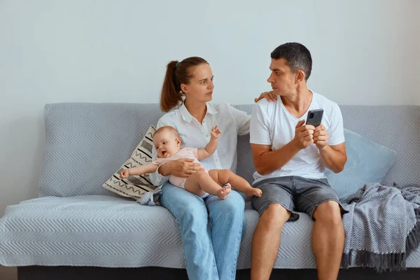 Indoor Shot Couple Sitting Sofa Living Room Baby Husband Using — Stock Photo, Image
