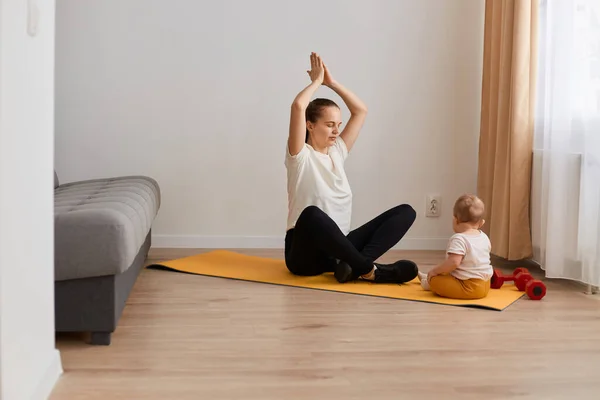 Indoor Tiro Jovem Mãe Faz Exercícios Ioga Física Juntamente Com — Fotografia de Stock