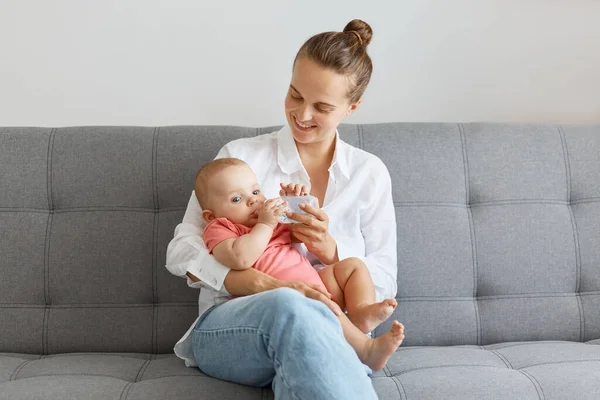 Indoor Shot Smiling Delighted Woman Bun Hairstyle Wearing White Shirt — Stock Photo, Image