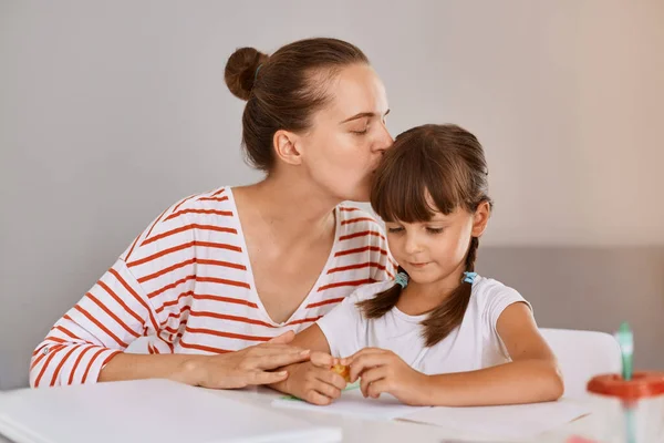 Portrait Loving Young Mother Sitting Schoolgirl Daughter Table Helping Homework — Stock Photo, Image