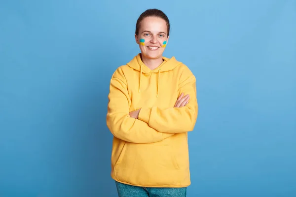 Indoor Shot Satisfied Confident Woman Yellow Hoodie Ukrainian Flag Cheeks — стоковое фото