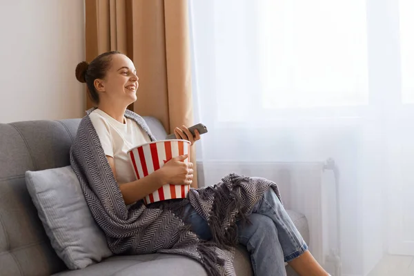 Horizontal Shot Smiling Happy Positive Woman Sitting Sofa Wrapped Blanket — Stock Photo, Image