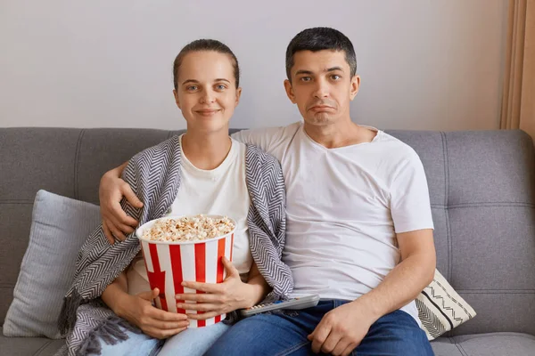 Indoor Shot Young Couple Watching Home Sitting Cough Hugging Wife — Fotografia de Stock