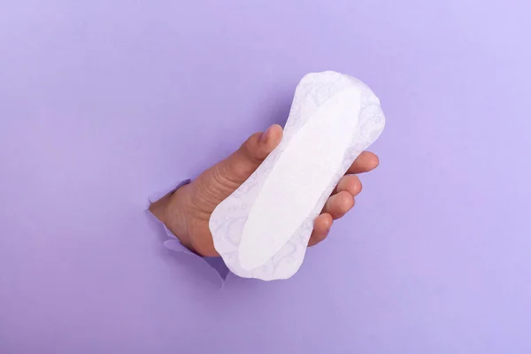 Sanitary Pads Women Human Hand Breaking Hole Purple Paper Wall — Stockfoto