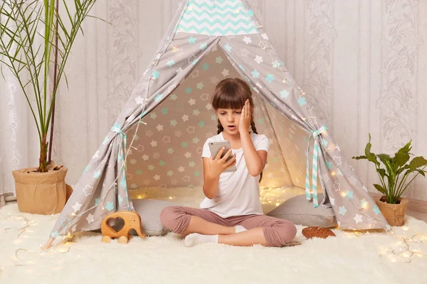Portrait Little Girl Sitting Home Teepee Playing Phone Holding Cell — Stock Fotó