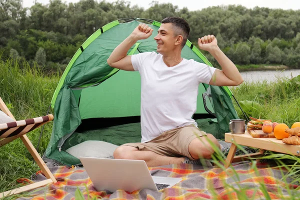 Horizontal Shot Happy Positive Man Freelancer Spending Time Nature Camping — Φωτογραφία Αρχείου