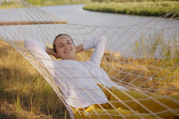 Outdoor Shot Smiling Relaxed Young Adult Woman Sitting Hammock Water — стоковое фото