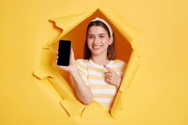 Portrait Smiling Positive Woman Wearing Striped Shirt Showing Cell Phone — Zdjęcie stockowe