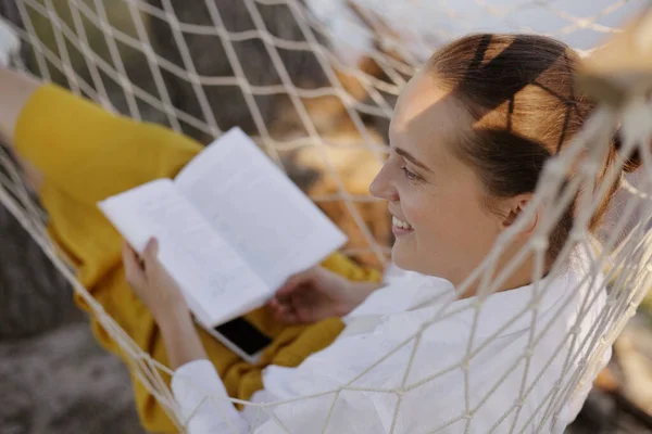 Side View Portrait Smiling Satisfied Woman Relaxing Hammock Holding Book — Stock fotografie