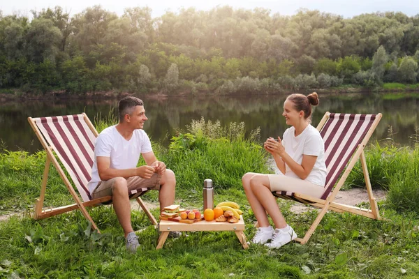 Horizontal Shot Smiling Happy Husband Wife Sitting Deck Chair Drinking — kuvapankkivalokuva