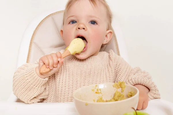 Image Funny Hungry Baby Girl Sitting Chair Eating Holding Spoon — Fotografia de Stock