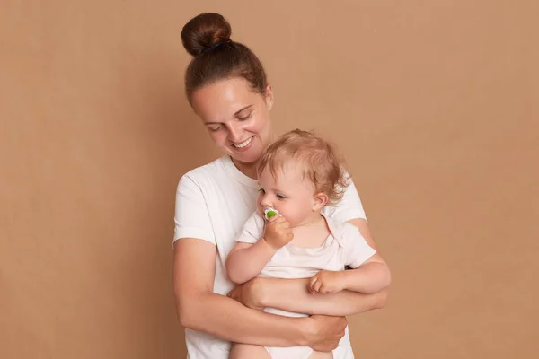 Portrait Smiling Loving Gentle Mother Hugging Baby Daughter Isolated Brown — Stock Photo, Image