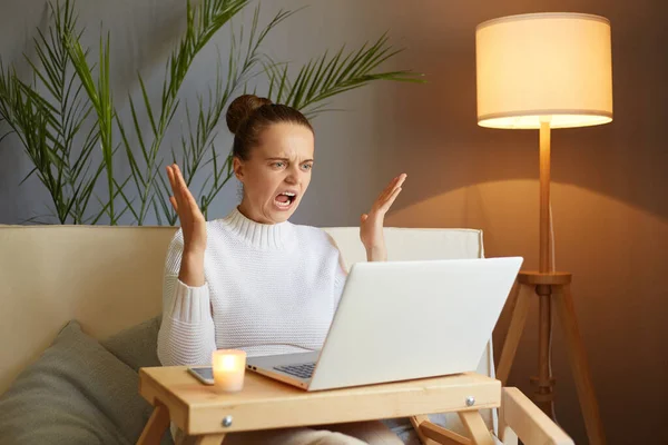Portrait Aggressive Angry Woman Wearing White Sweater Sitting Sofa Working — Stock Photo, Image