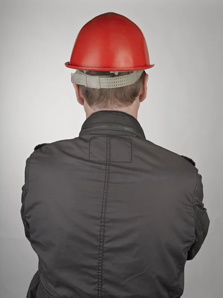Back of worker man on grey background — Stock Photo, Image