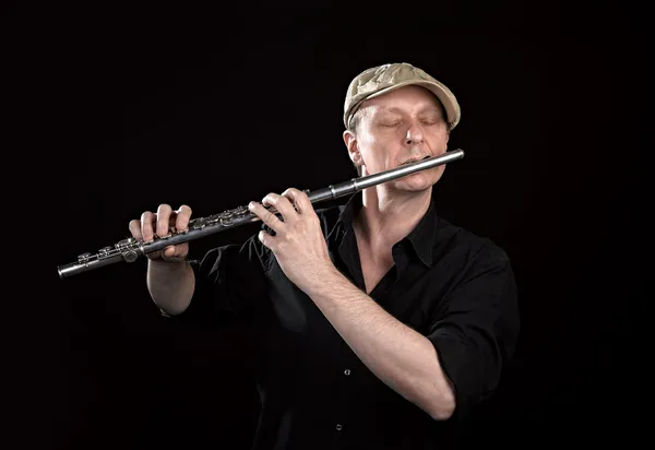 Portrait of a man playing old silver transverse flute — Stock Photo, Image