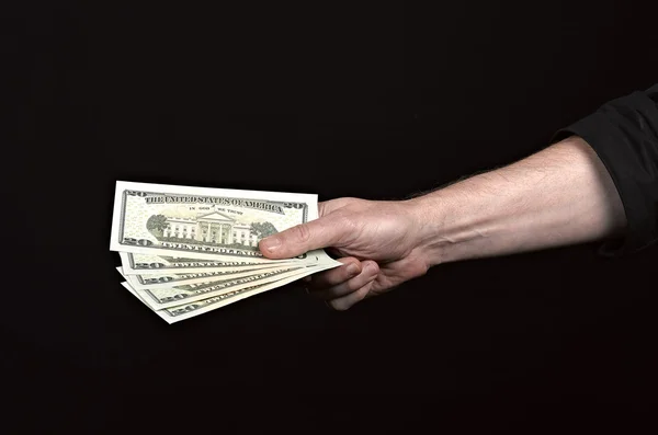 Money on the hands, isolated on black background — Stock Photo, Image