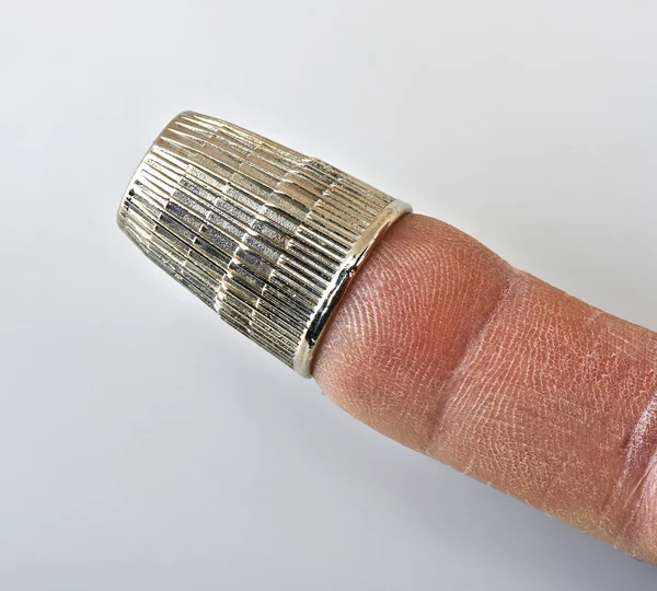 Thimble on finger — Stock Photo, Image