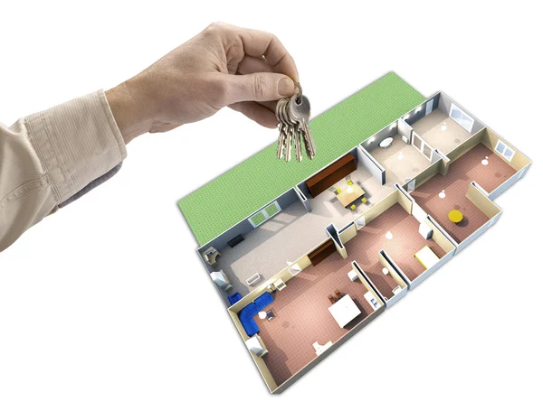 Ruka drží klíče, dům mapa v pozadí — Stock fotografie