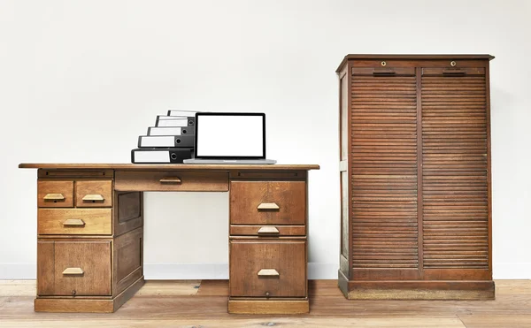 Laptop and folder lying on a vintage desk — Stock Photo, Image