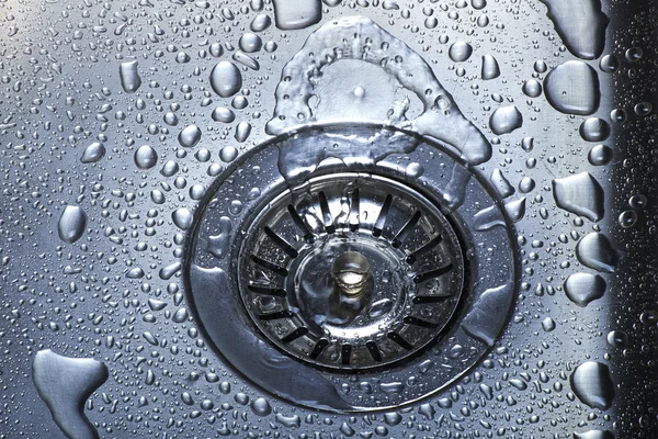 Water and droplets in sink — Stock Photo, Image
