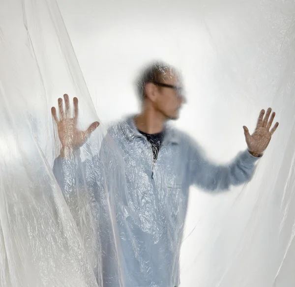 Silhouette of a man behind a transparent plastic — Stock Photo, Image