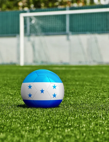 Soccer Ball with Honduras Flag on the grass in stadium — Stock Photo, Image