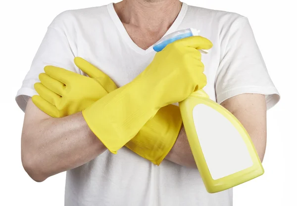 Studio shot of a man with rubber glove holding a cleaning spray — Stock Photo, Image