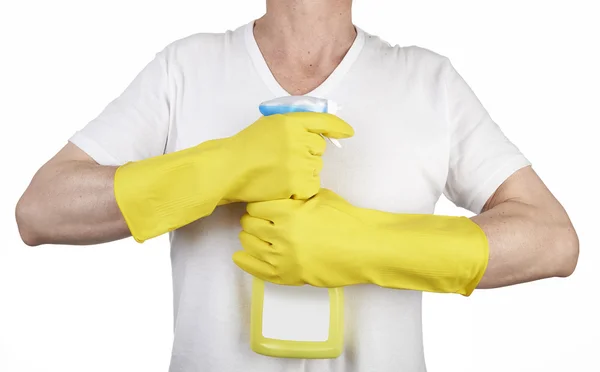 Studio shot of a man with rubber glove holding a cleaning spray — Stock Photo, Image