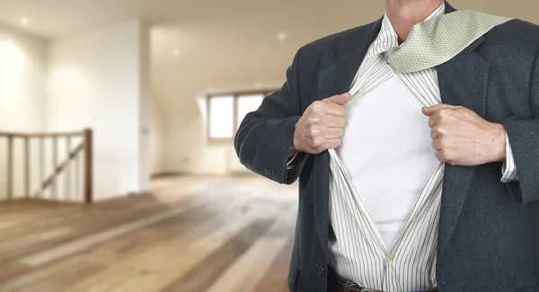 Businessman showing shirt  against clock — Stock Photo, Image