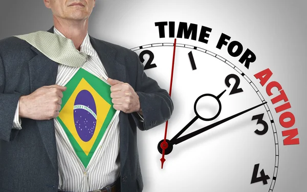 Businessman showing shirt with flag from Brazil suit against clo — Stock Photo, Image