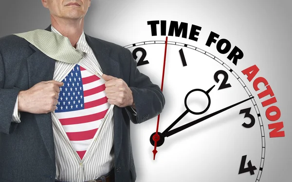 Businessman showing shirt with flag from USA suit against clock — Stock Photo, Image