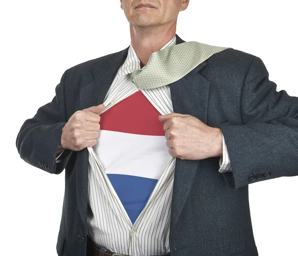 Businessman showing Netherlands flag superhero suit underneath h — Stock Photo, Image