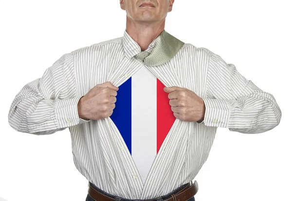 Businessman showing a superhero French suit underneath his shirt — Stock Photo, Image